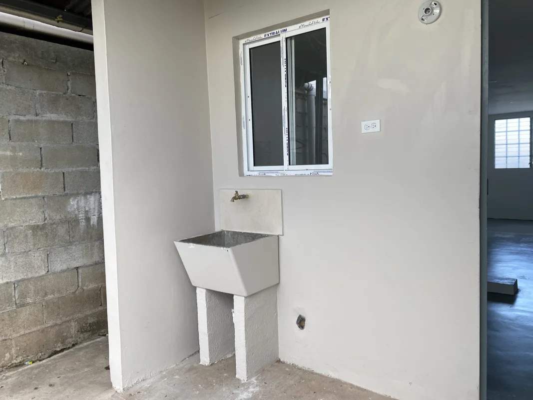 Outdoor washing station concrete sink and faucet Altos de San Ángel house