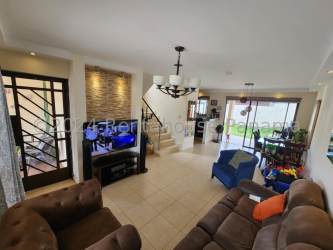 Living room area with staircase, TV and sofas at Residencial Los Robles La Chorrera Panama