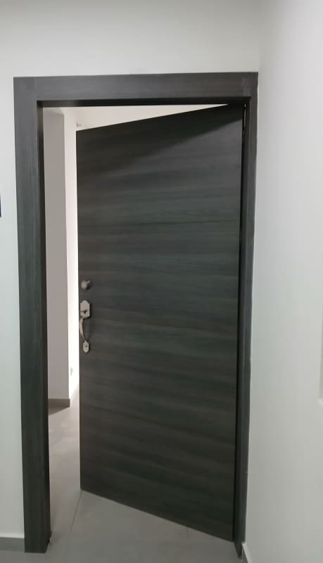 Modern hallway with secure door and gray tile floor in Signature Point Panama