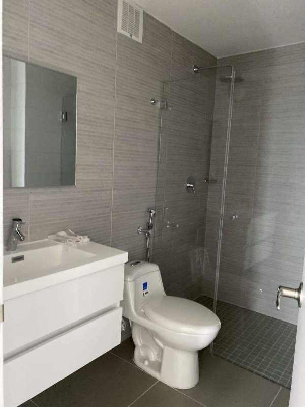 Modern bathroom with walk-in glass shower and floating vanity at PH Altamira Residences Panama City