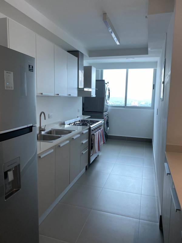 Contemporary white kitchen with built-in laundry area at PH Altamira Residences Bella Vista Panama