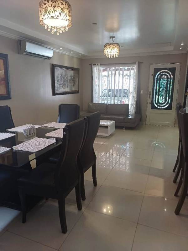 Open plan living dining space with large windows tile floors in Altos del Chase house for sale
