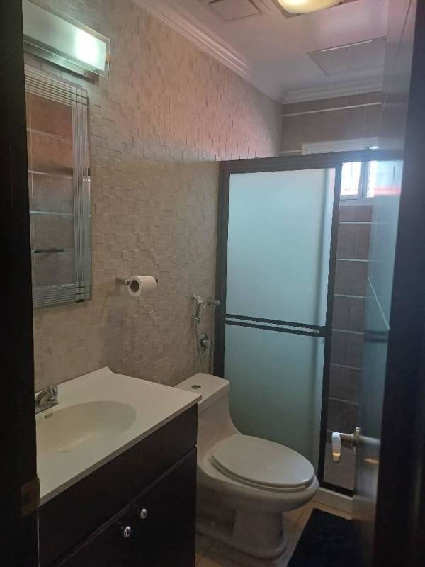 Modern bathroom with glass shower and beige tiles in Altos del Chase El Dorado house