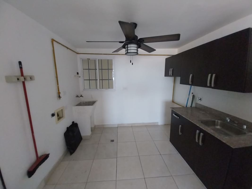 Spacious bedroom with ceiling fan, built-in wardrobe and large window at PH Altavista Tower Condado del Rey