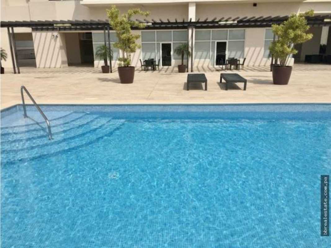 Modern outdoor pool with lounge chairs, pergola and landscaping at PH Zeus Costa del Este