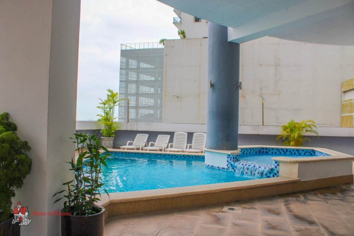 Swimming pool with lounge space and skyline views at PH Rocamar Panama City