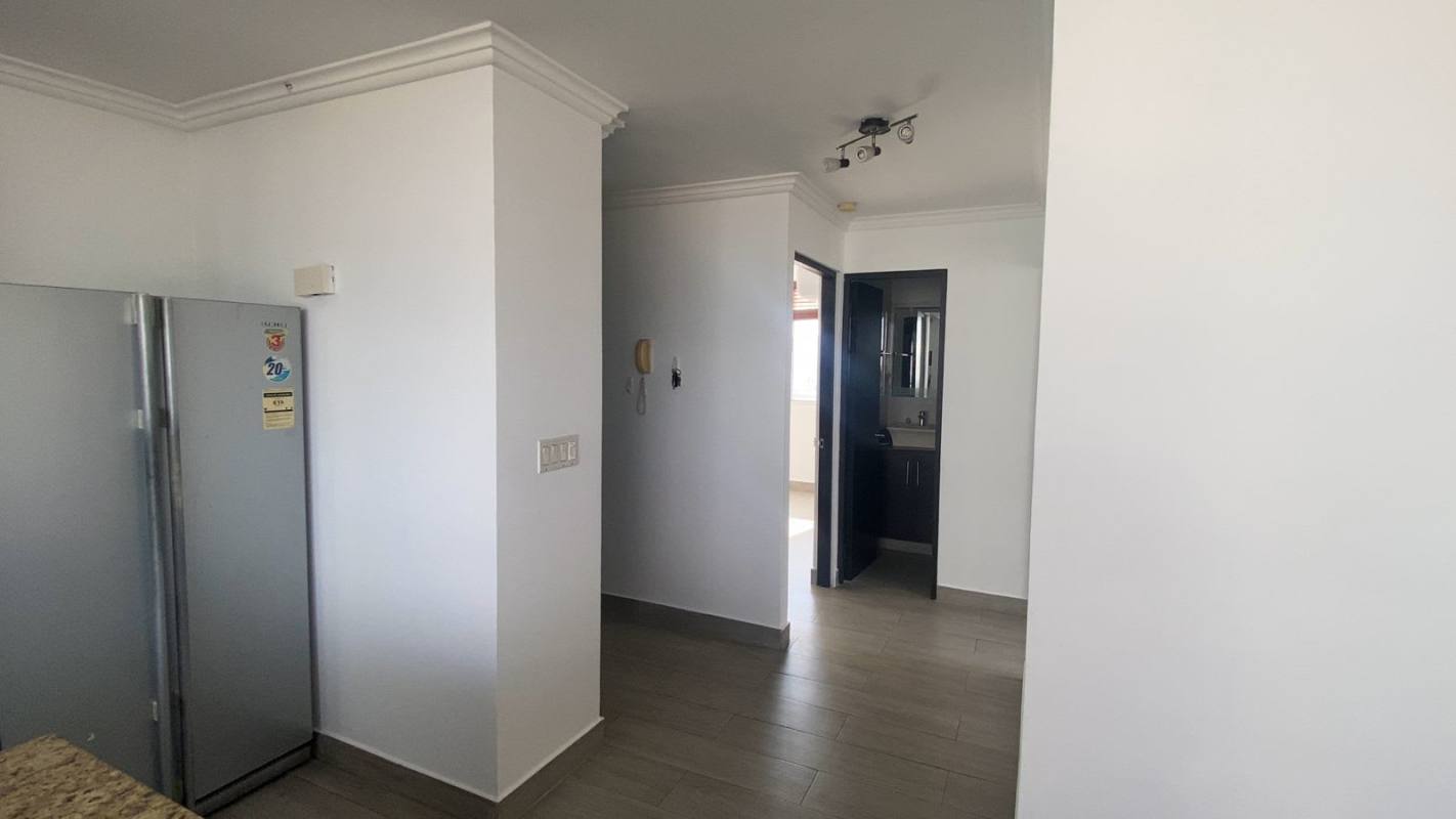 Modern interior halls adjacent to kitchen and bath with tile floors PH Montemar Panama