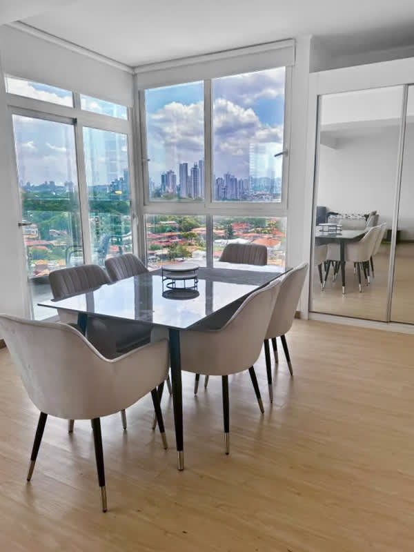 Dining area with floor-to-ceiling windows and skyline view PH Quartier Coco del Mar