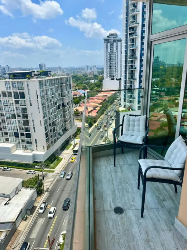 Open-concept living room with balcony skyline view PH Quartier Panama City