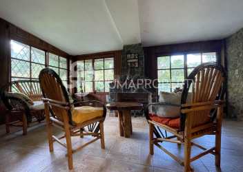 Rustic bathroom with stone walls, walk-in mosaic tile shower in Valle de Antón mountain home Panama