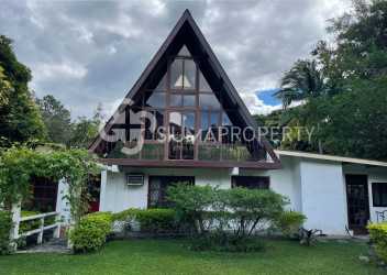 Private gated entrance with stone pillars and lush landscaping country house Valle de Antón Panama