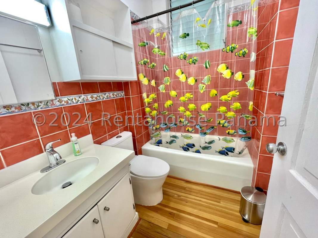 Dining and living room with wood floors and large windows in Ancón, Panama City