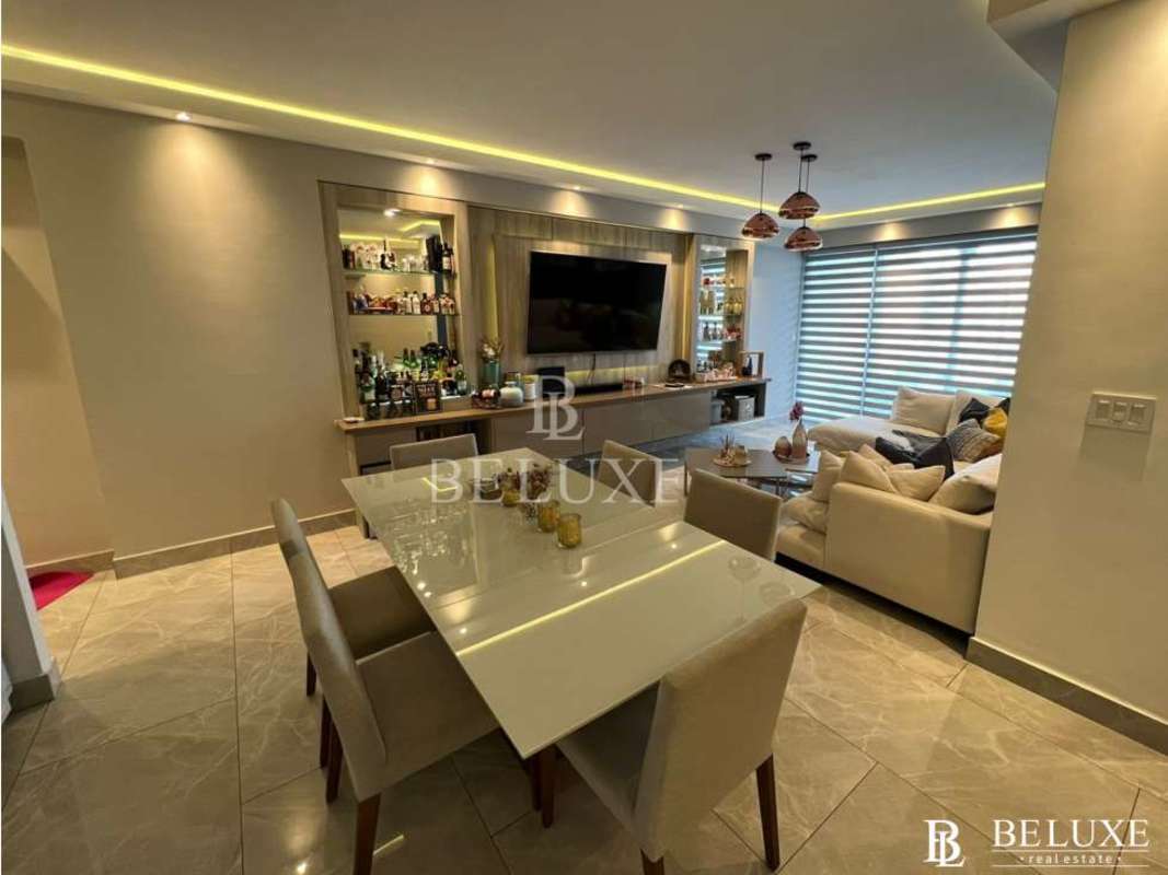 Modern open living room with city view balcony in PH Premium Tower San Francisco Panama