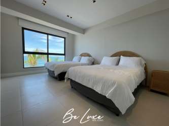 Modern open-plan living room with balcony access and beachfront views Punta Caelo San Carlos Panama