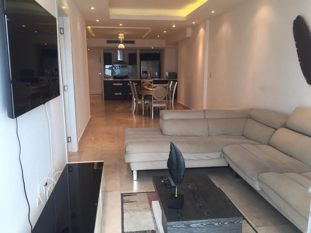 Modern bathroom featuring marble walls, glass-enclosed shower in PH Yoo Panama apartment