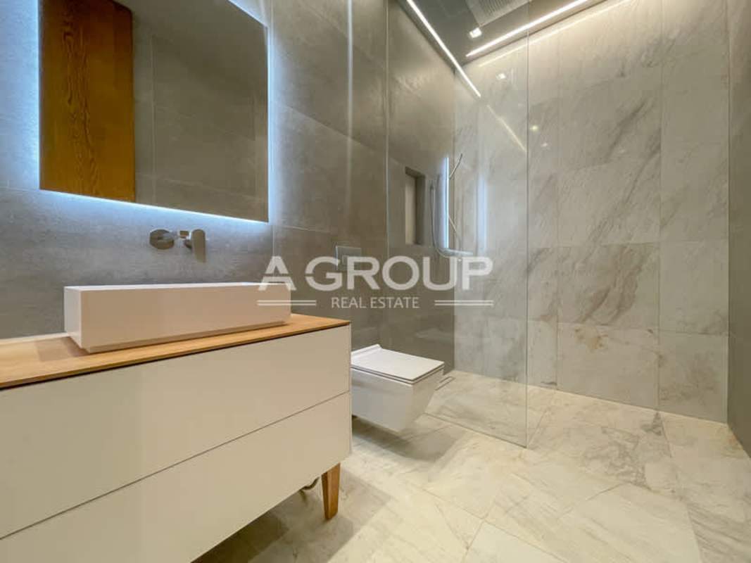 Master bedroom with ocean view floor to ceiling glass windows marble floors in luxury Ocean House apartment