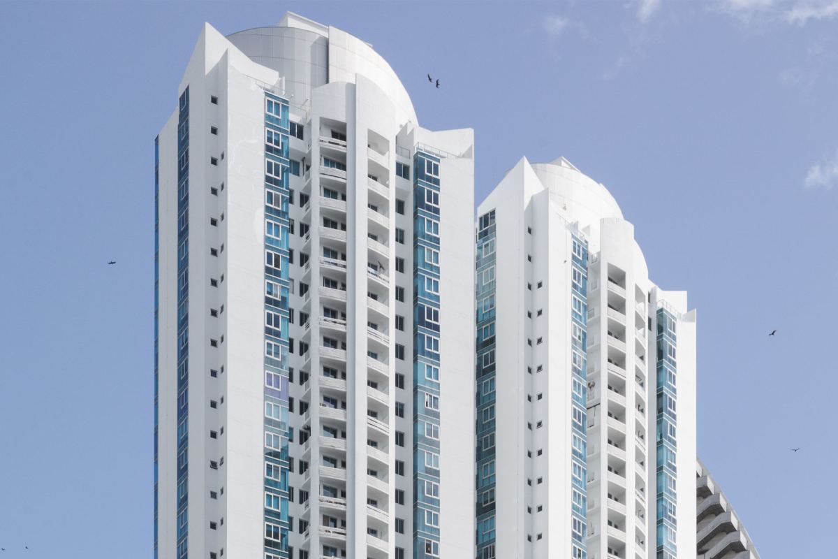 Luxury twin high-rise towers with balconies and glass facade at Pacific Village Panama City