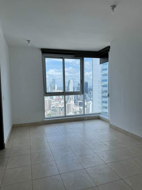 Modern apartment living room with floor-to-ceiling windows and ocean view at Pacific Village Punta Pacifica