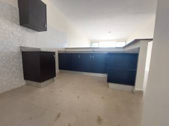 Kitchen with tile backsplash, counter space, window, and storage in Hato Montaña La Chorrera Panama