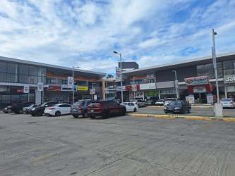 Exterior contemporary architectural design of shopping plaza with large parking Penonomé Panama