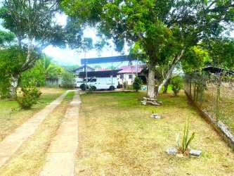 Rustic covered porch overlooking spacious fenced yard at estate in Arraiján Panama