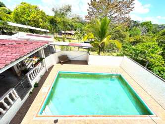 Large living room with ceiling fans and natural light in rustic country house Arraiján Panama