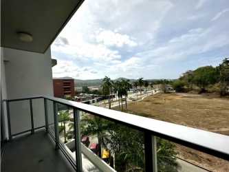 Dining area adjacent to modern kitchen PH Mosaic apartment Panama Pacifico