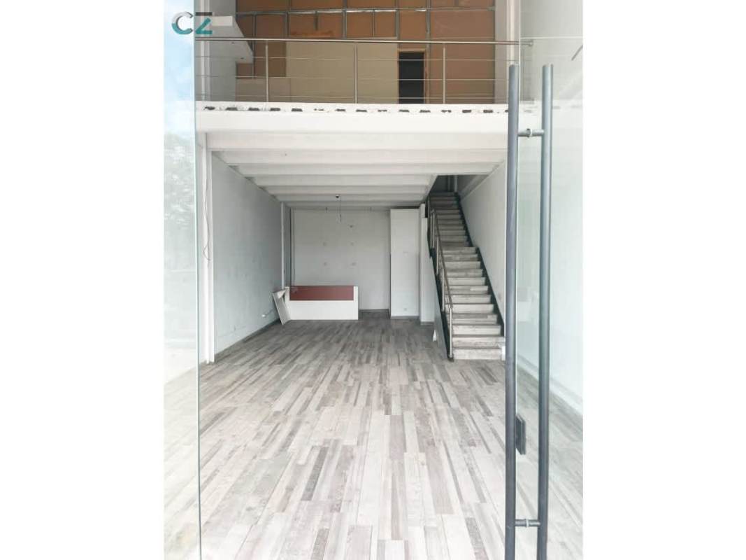 Interior loft mezzanine office area with wood flooring, metal railing, high ceiling at Midtown Plaza Panama