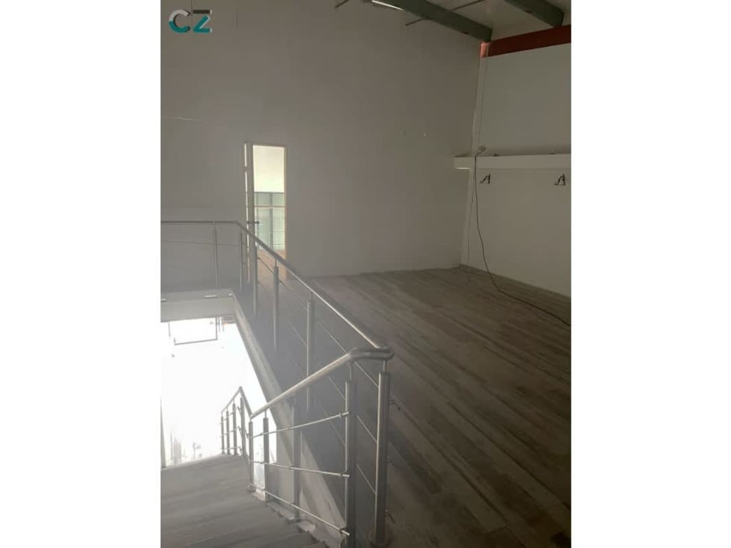 Commercial unit glass entry, floating stair, wood tile floors at Midtown Plaza Panama