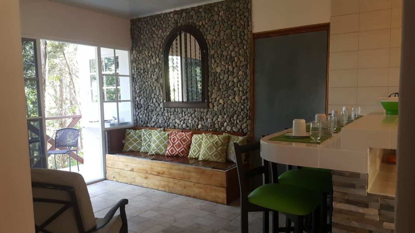 Rustic living dining space with breakfast bar at Altos de Cerro Azul Panama