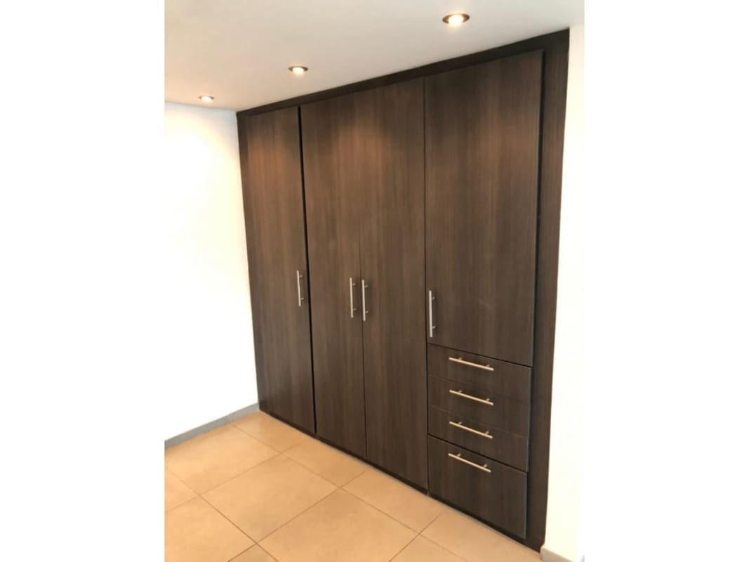 Modern built-in closet with recessed lighting in PH Yacht Club master suite Panama City