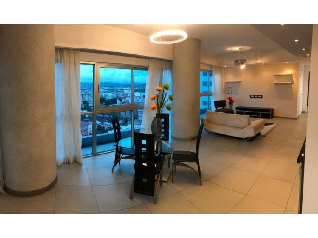 Living room with modern decor and panoramic skyline view in PH Yacht Club Panama City
