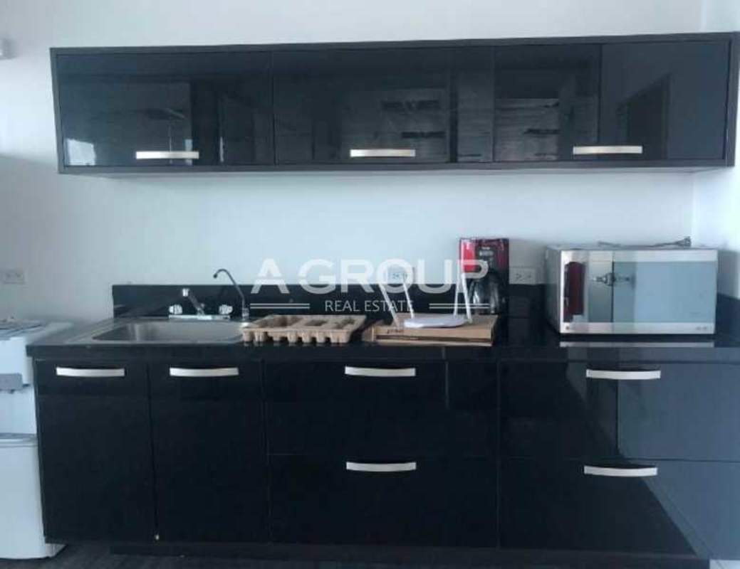 Glass-partitioned office workspace with furniture in Oceania Business Plaza Punta Pacífica