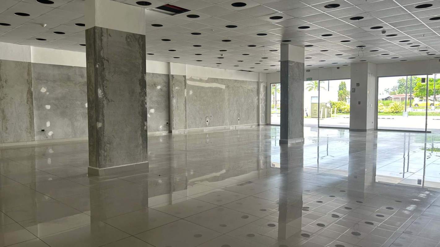 Spacious unfinished commercial retail unit with large glass windows and tiled floors Tocumen Plaza Panama