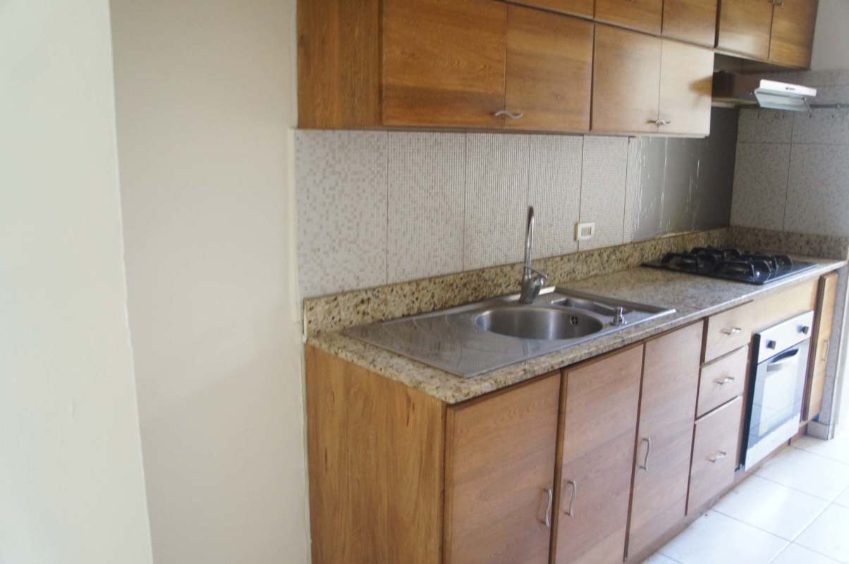 Granite kitchen countertop with stove and cabinets in PH Metro Park View Panama City