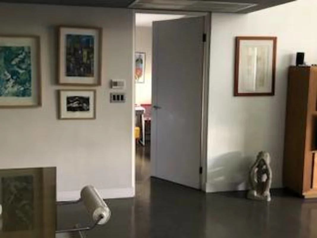 Bright modern open plan loft with glass railing and recessed lighting at PH Porta Nova