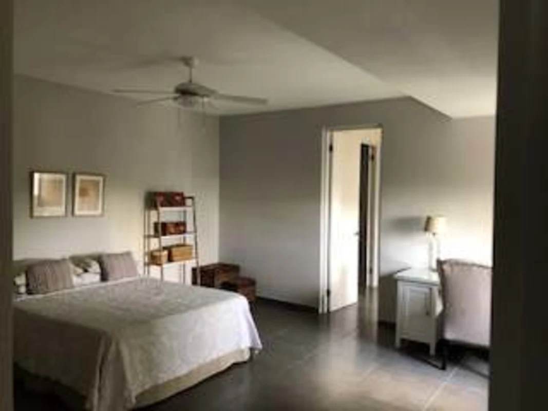 Bedroom with two beds, large windows, ceiling fan in PH Porta Nova loft Panama