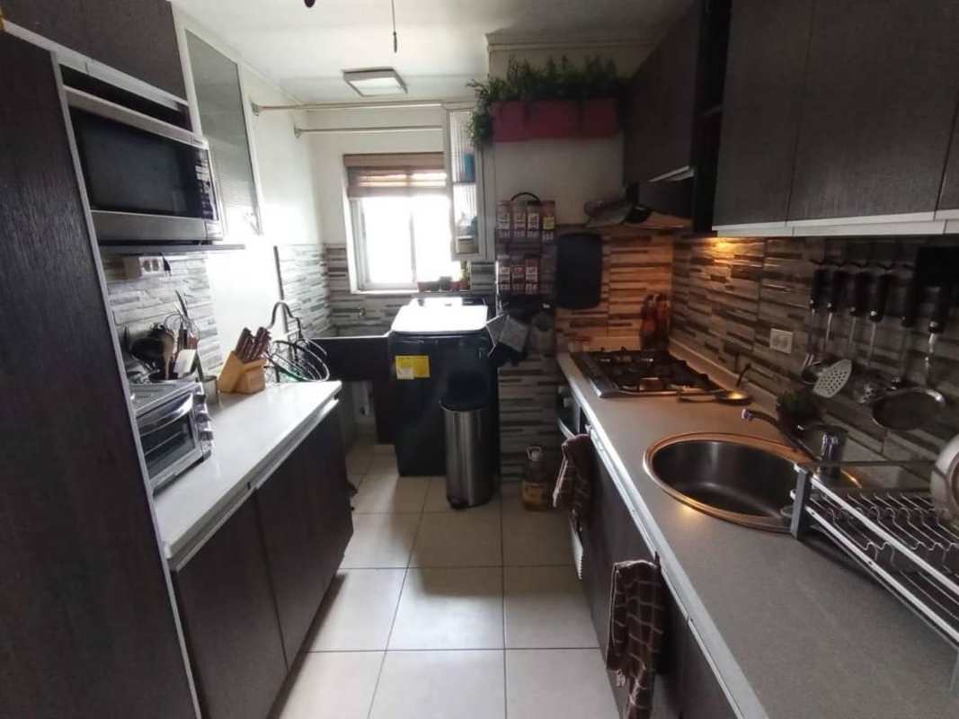 Modern living dining with large window and balcony behind blinds in PH Rio Abajo Panama City