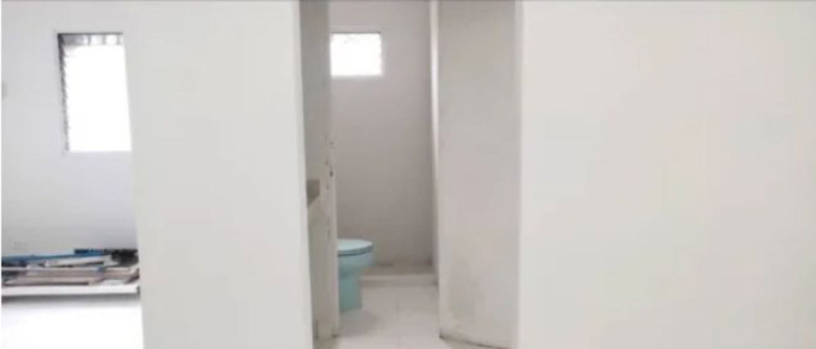 Basic minimalist bathroom with small window and white walls in Edificio Z1 Los Libertadores Panama City