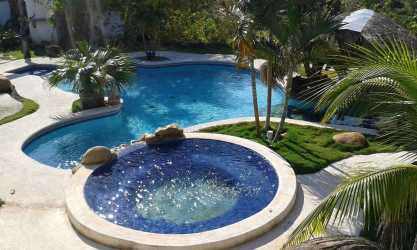 Covered terrace near private pool overlooking ocean and mountain views at farm estate Rodeo Viejo San Carlos Panama