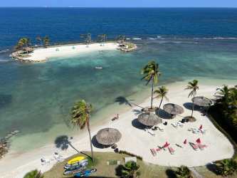 Contemporary open concept living dining area with natural light and patio access in Playa Escondida beach condo Colon Panama