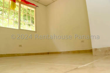Spacious bedroom with tile floors and large window at La Isabella gated house Arraiján Panama