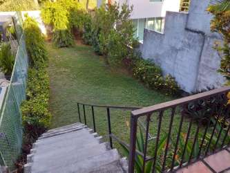 Landscaped private backyard with concrete stairs, plants and privacy walls in Coronado Panama duplex
