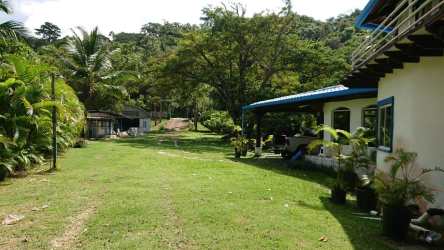 Outdoor shaded terrace overlooking garden and swimming pool in Colon Panama