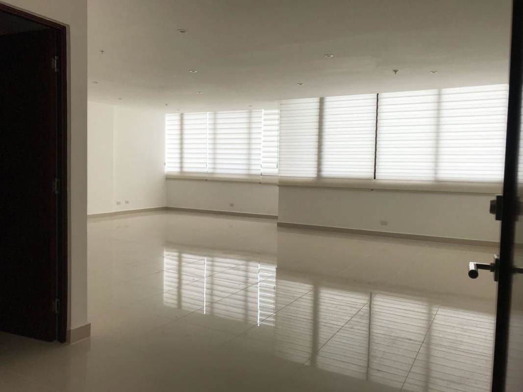 Minimalist empty living room with glossy tile floors and windows PH Brisa Marina Panama