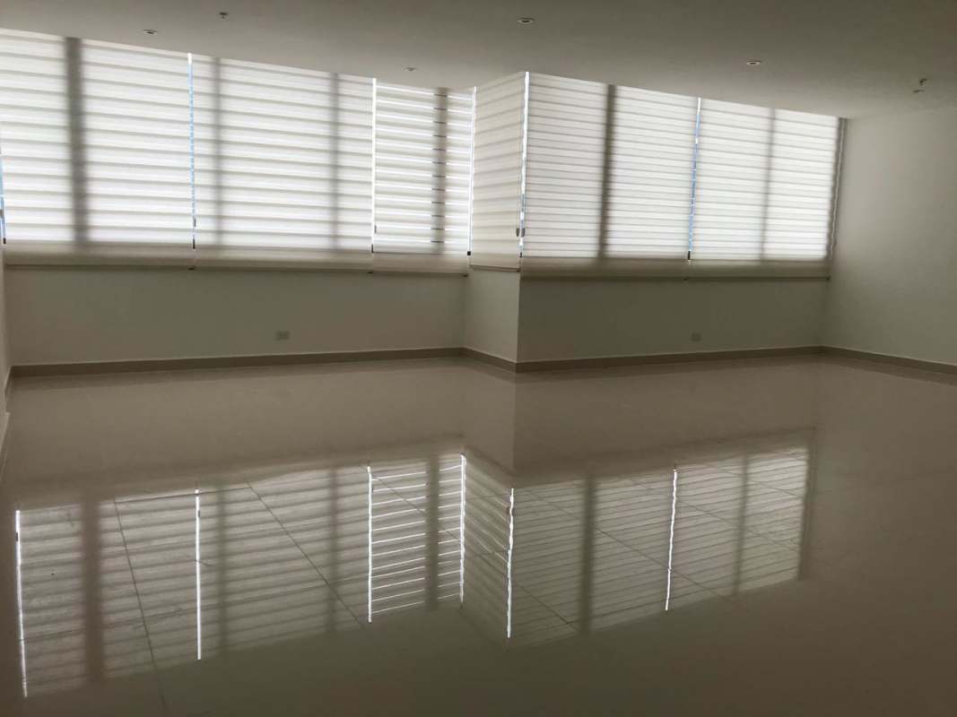 Large corner windows and tiled floor empty living room at PH Brisa Marina Costa del Este