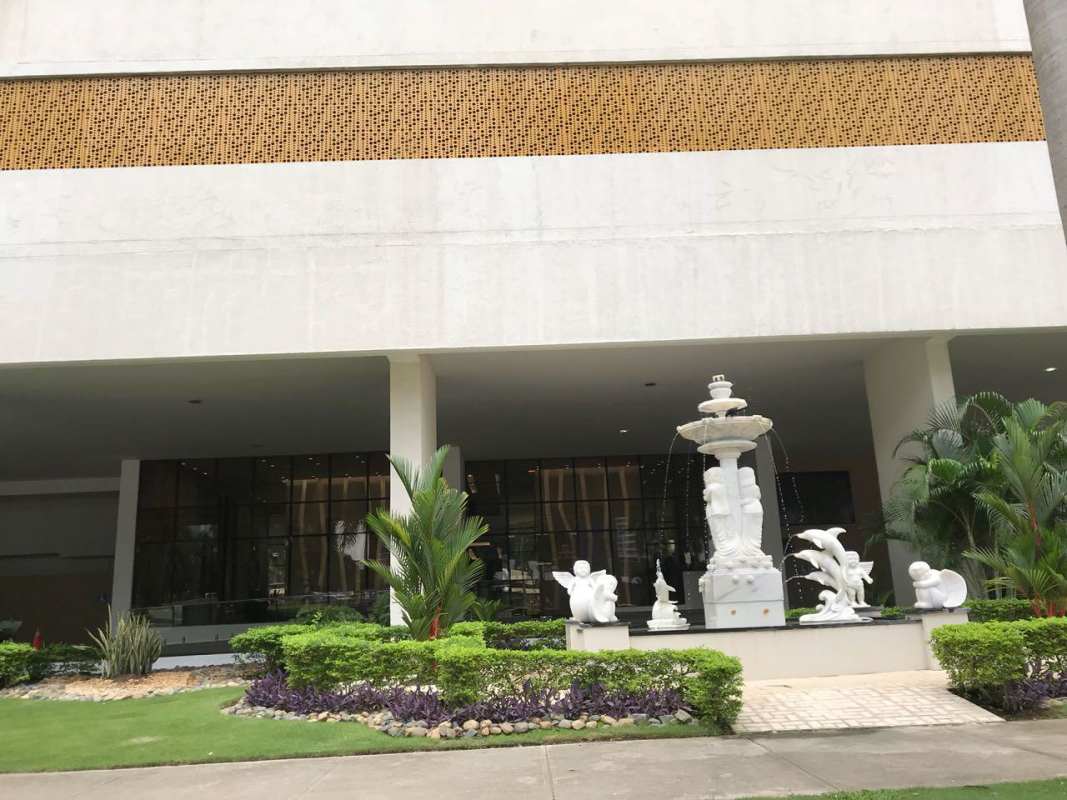 Modern tower with sculpture water fountain landscaped entrance PH Brisa Marina Panama