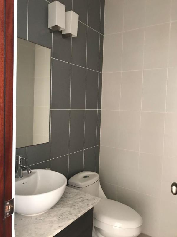 Stylish modern bathroom with vessel sink marble countertop glass shower PH Brisa Marina Panama