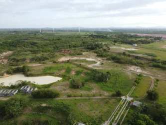 View of rural countryside property showing large open land and ponds under cloudy skies in Coclé Panama
