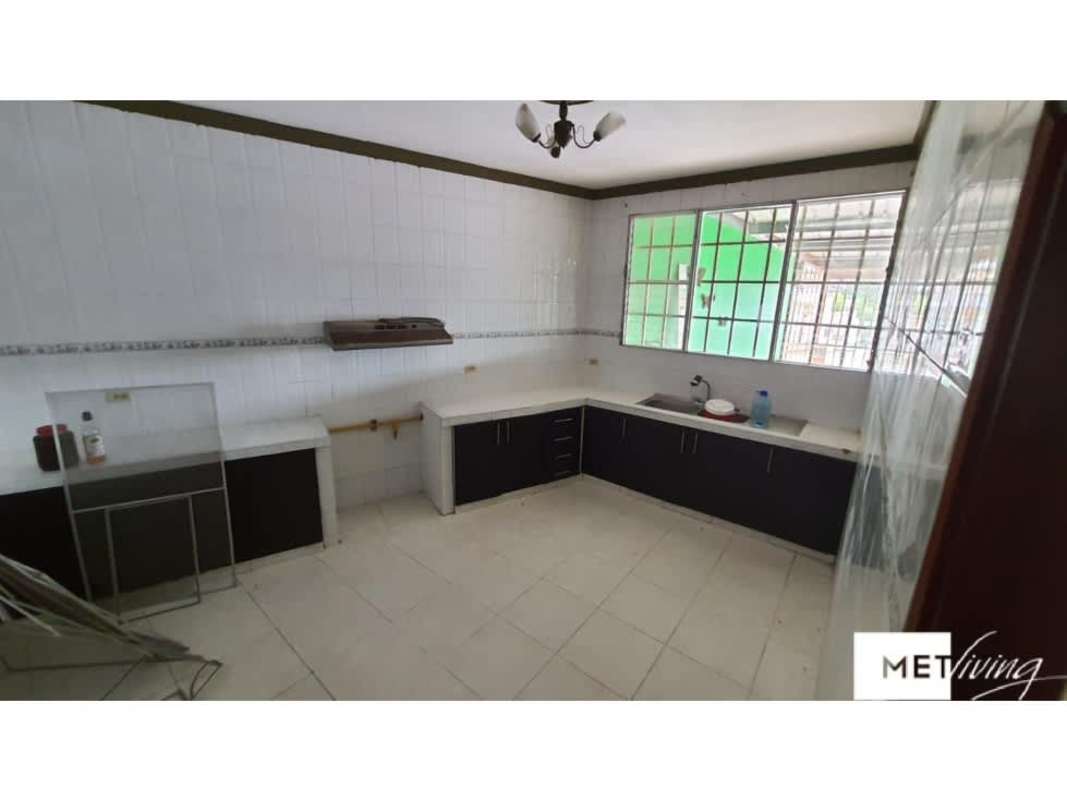 Kitchen with tiled walls and counters black cabinets large window Panama